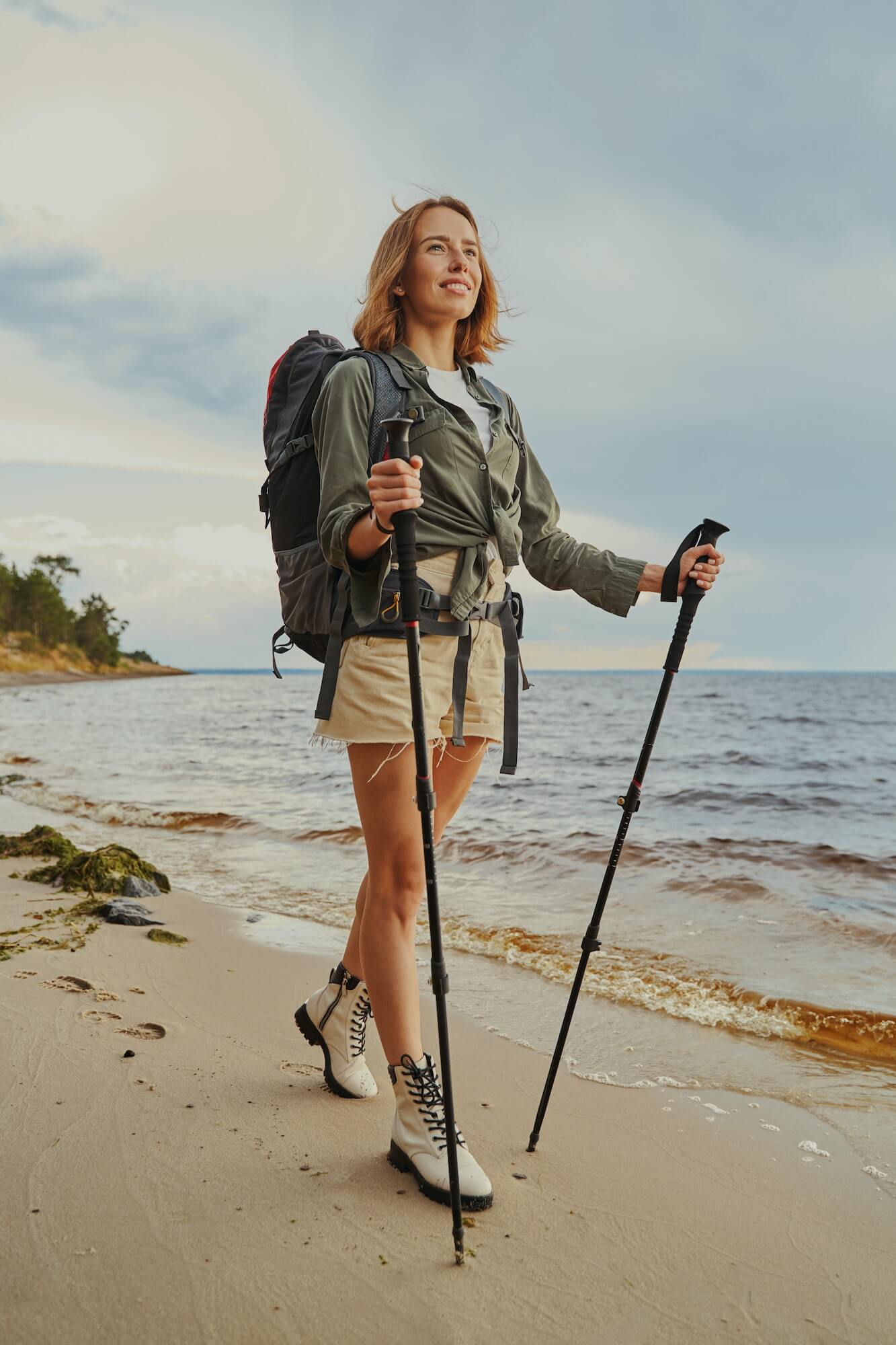 optimistic-traveller-using-walking-poles-during-beach-stroll-1.jpg